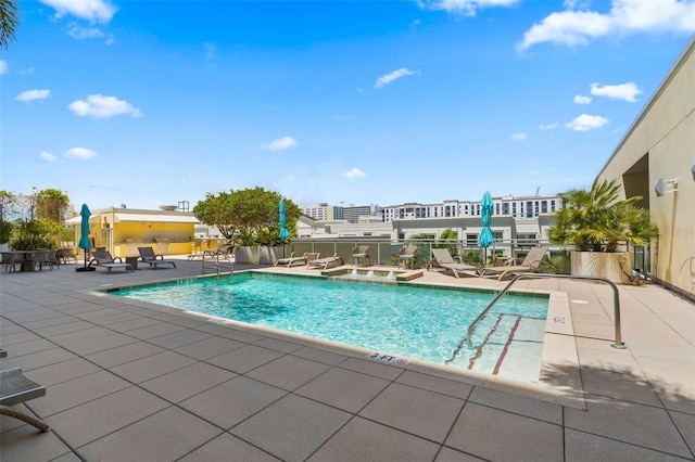 pool featuring a patio area and a hot tub