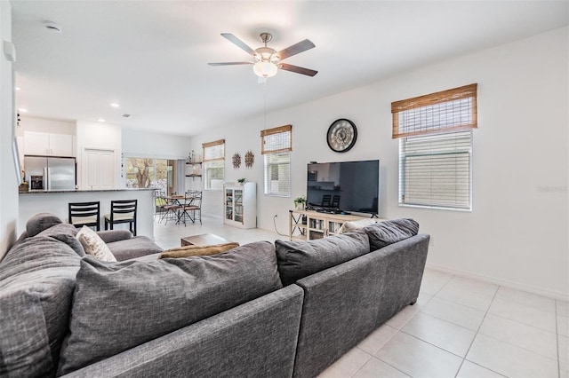 living area with light tile patterned floors, ceiling fan, baseboards, and recessed lighting