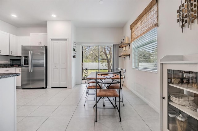 dining room featuring light tile patterned floors, baseboards, and recessed lighting