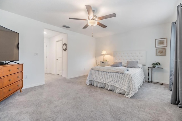 bedroom with light carpet, a ceiling fan, visible vents, and baseboards