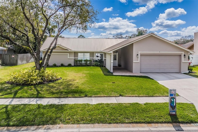 ranch-style home with stucco siding, concrete driveway, an attached garage, a front yard, and metal roof