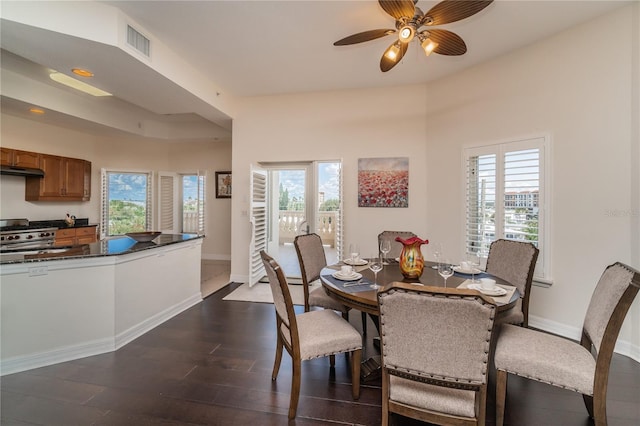 dining area featuring a ceiling fan, baseboards, visible vents, and dark wood-style flooring