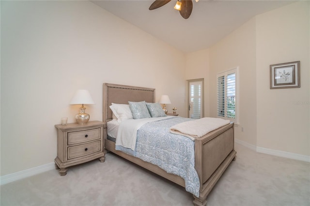 bedroom featuring lofted ceiling, light colored carpet, ceiling fan, and baseboards