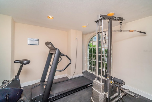 workout area with baseboards and recessed lighting