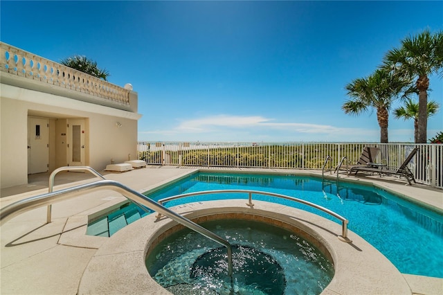 view of swimming pool with a patio, fence, a fenced in pool, and a hot tub