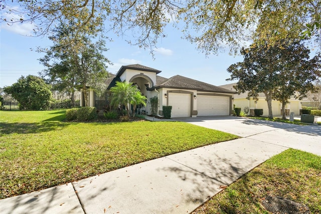 mediterranean / spanish home featuring an attached garage, a front lawn, concrete driveway, and stucco siding