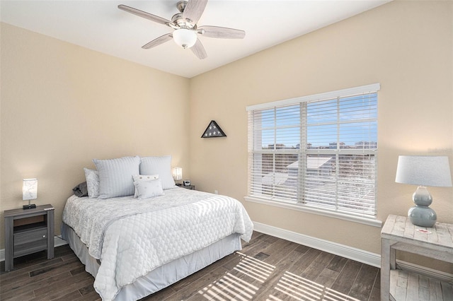 bedroom featuring a ceiling fan, baseboards, and wood finished floors
