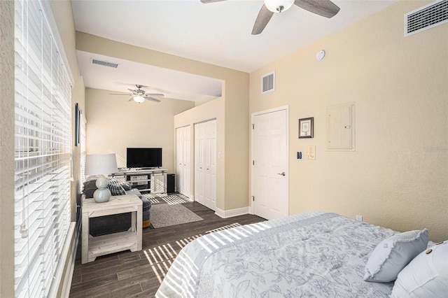 bedroom featuring dark wood-style floors, electric panel, visible vents, and a closet