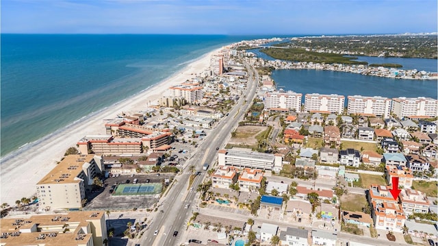 drone / aerial view featuring a water view and a beach view