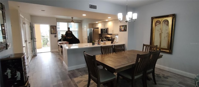 dining space with recessed lighting, visible vents, baseboards, dark wood-style floors, and an inviting chandelier