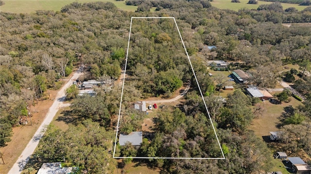 drone / aerial view with a view of trees