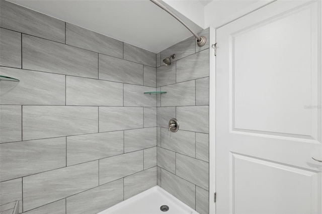 bathroom with tiled shower