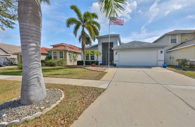 view of front of house with a garage, stucco siding, driveway, and a front yard