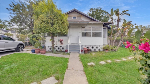 bungalow featuring a front yard and entry steps