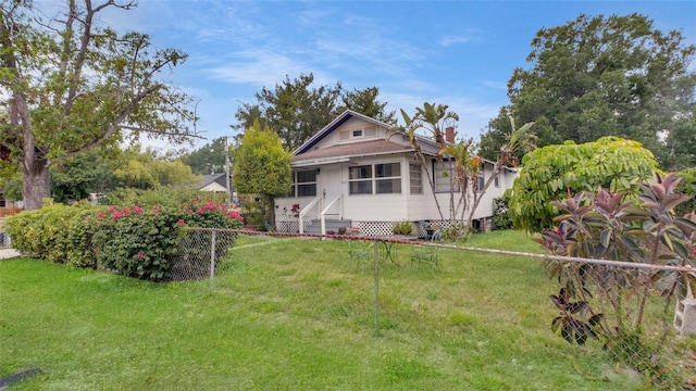 exterior space with a front lawn and fence