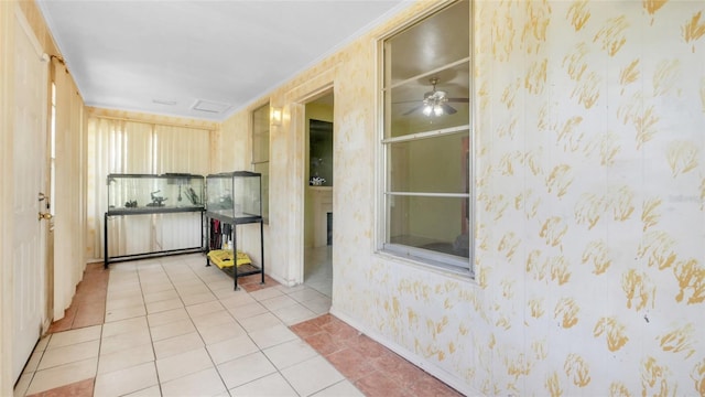 kitchen featuring light tile patterned flooring, wallpapered walls, ceiling fan, and baseboards