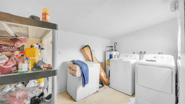 washroom with independent washer and dryer, laundry area, and electric water heater