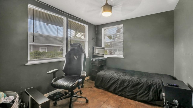 bedroom with tile patterned flooring and a ceiling fan