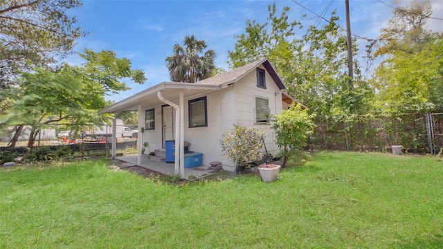 view of side of property with a lawn and a fenced backyard