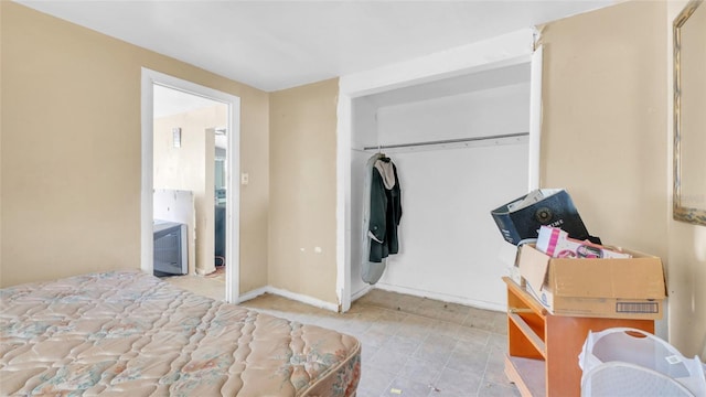 bedroom featuring baseboards and a closet