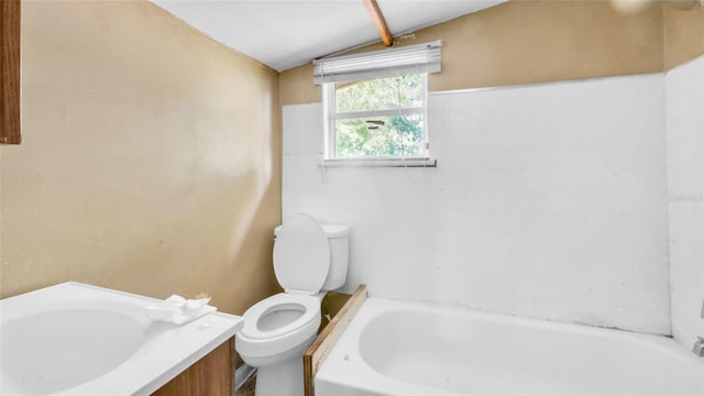 bathroom featuring a bath, toilet, and lofted ceiling