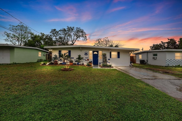 single story home with central air condition unit, a front lawn, and stucco siding