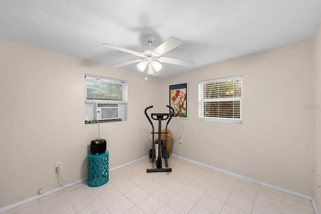 workout area with a ceiling fan, cooling unit, a wealth of natural light, and baseboards