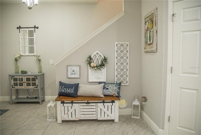 sitting room with marble finish floor and baseboards