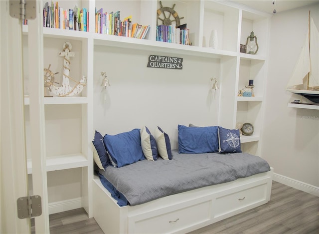 mudroom featuring baseboards and wood finished floors