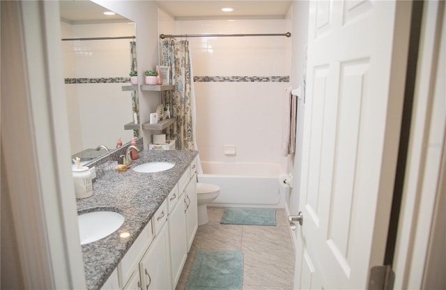 bathroom with shower / tub combo, a sink, toilet, and double vanity