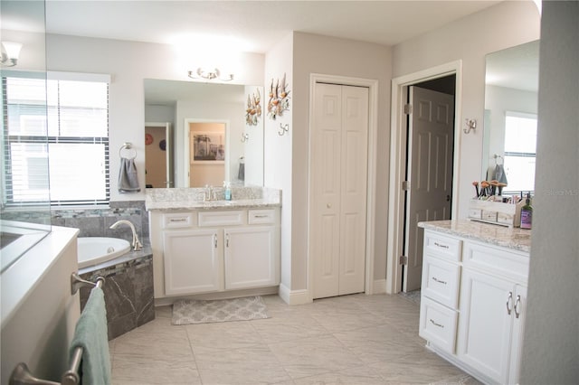 full bathroom with a garden tub, a closet, and vanity