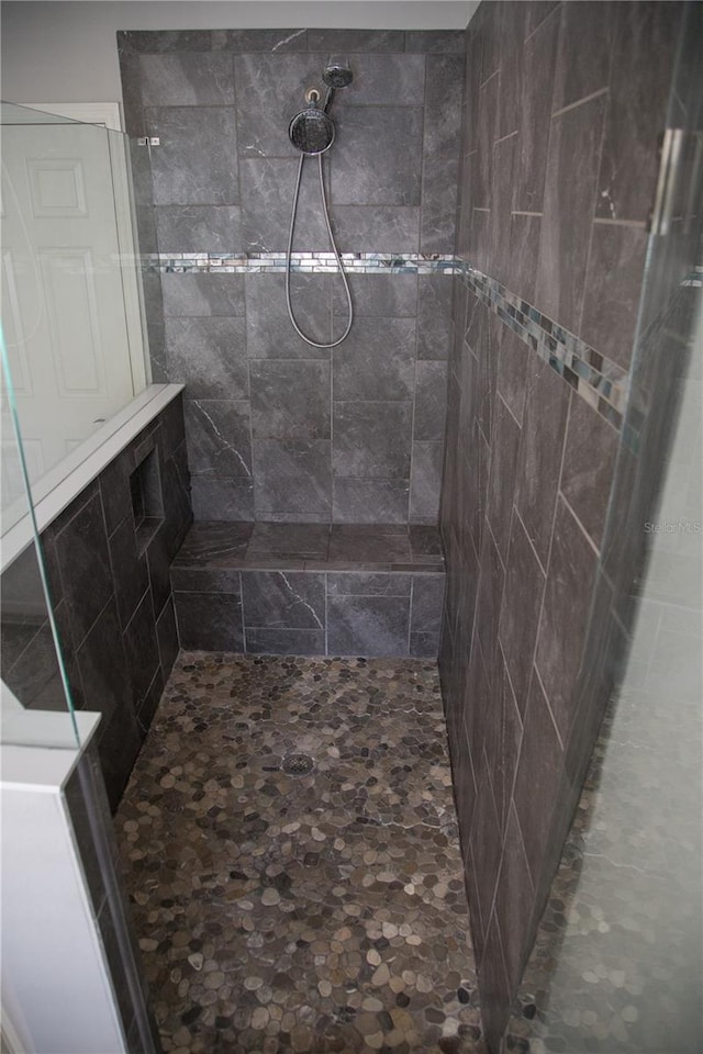 bathroom with tiled shower