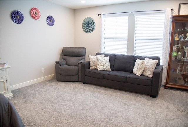 carpeted living area with baseboards and recessed lighting