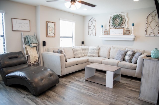 living room featuring wood finished floors, a ceiling fan, and recessed lighting