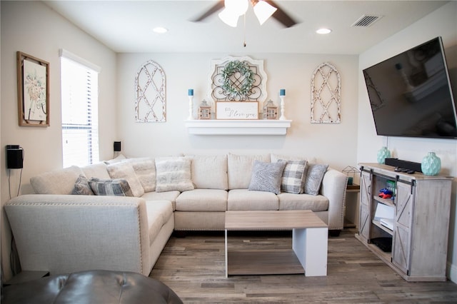 living room featuring ceiling fan, visible vents, wood finished floors, and recessed lighting