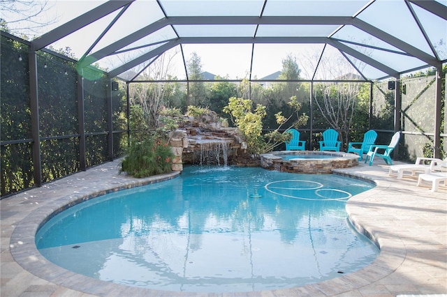 view of pool featuring a lanai, a patio area, and a pool with connected hot tub