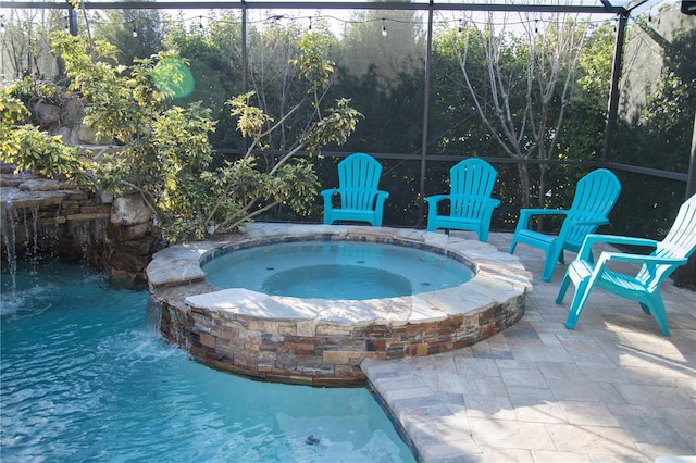 view of swimming pool with a patio area, a lanai, and a pool with connected hot tub