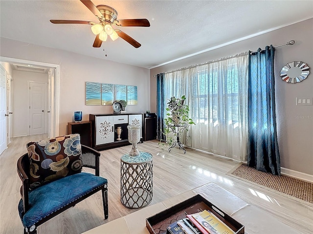 4100 Narvarez Way S, Saint Petersburg, FL 33712 - living room featuring a ceiling fan, wood finished floors, baseboards, and a textured ceiling