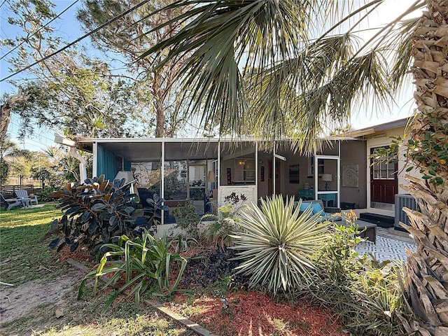 4100 Narvarez Way S, Saint Petersburg, FL 33712 - back of property with a sunroom, central air condition unit, a patio, and a fire pit