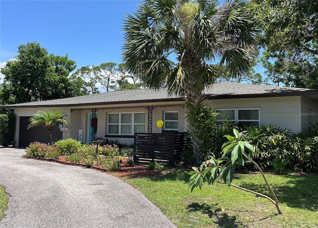 4100 Narvarez Way S, Saint Petersburg, FL 33712 - ranch-style home with an attached garage, brick siding, asphalt driveway, and a front yard