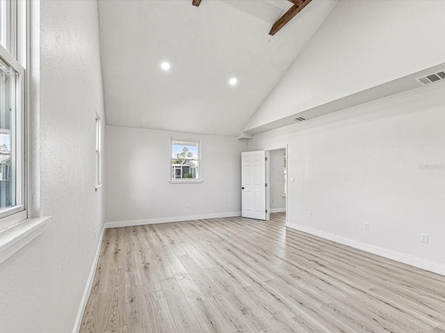 empty room with light wood-type flooring, baseboards, and visible vents