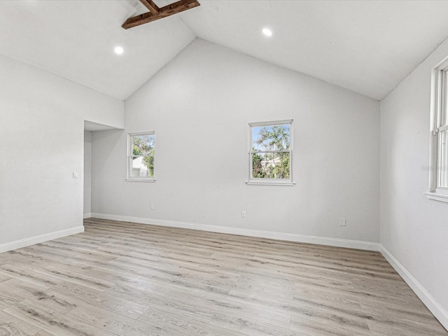 unfurnished room featuring light wood-style floors, baseboards, high vaulted ceiling, and recessed lighting