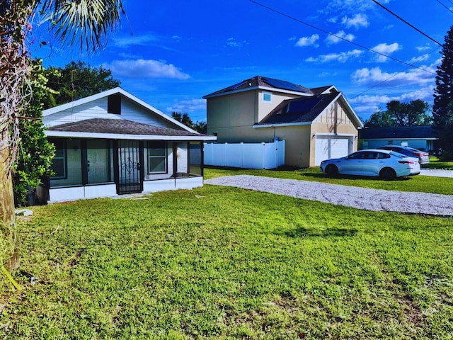 view of front facade with roof with shingles, fence, a porch, and a front yard