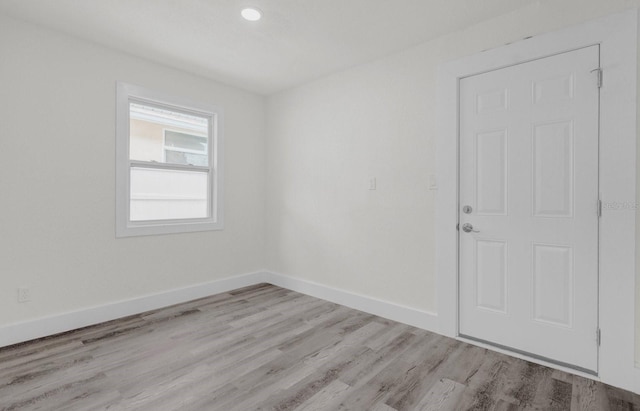 empty room featuring light wood-style flooring and baseboards