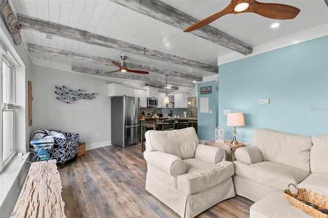 living area with a ceiling fan, dark wood finished floors, beamed ceiling, and baseboards