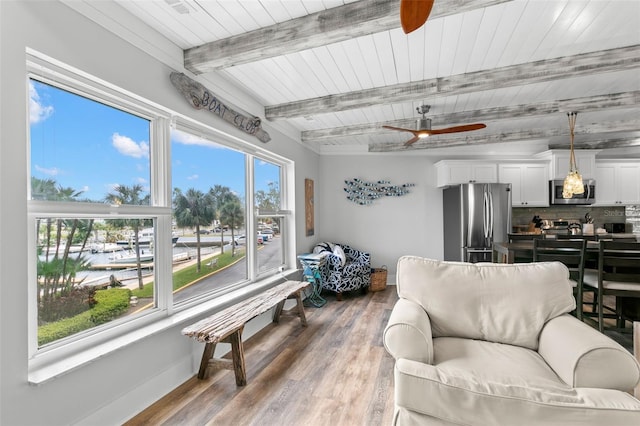 living room with a ceiling fan, wooden ceiling, beam ceiling, and light wood-style floors