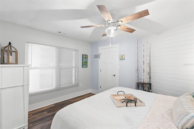 bedroom featuring ceiling fan, baseboards, visible vents, and dark wood finished floors