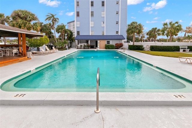 community pool featuring a patio and fence