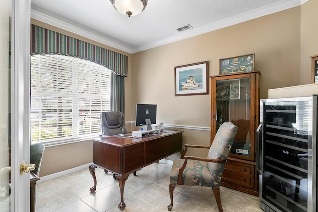 office area with wine cooler, light tile patterned flooring, crown molding, and baseboards