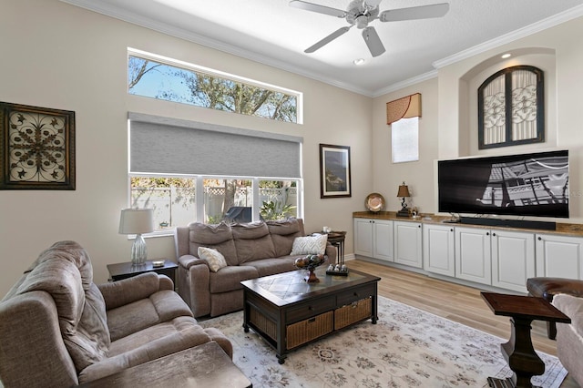 living room with light wood-style floors, plenty of natural light, and ornamental molding